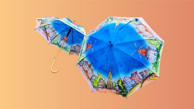 Das Bild zeigt zwei bunte Regenschirme mit gemalten Motiven aus Peine drauf. 