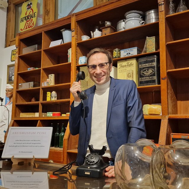 Kurator Marcus Peter vom Kreismuseum Peine demonstriert, wie künftig über das Telefon Informationen zu Ausstellungsstücken abgerufen  werden sollen.