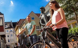 Das Bild zeigt ein Pärchen mit Fahrrädern auf dem Echternplatz in Peine. 
